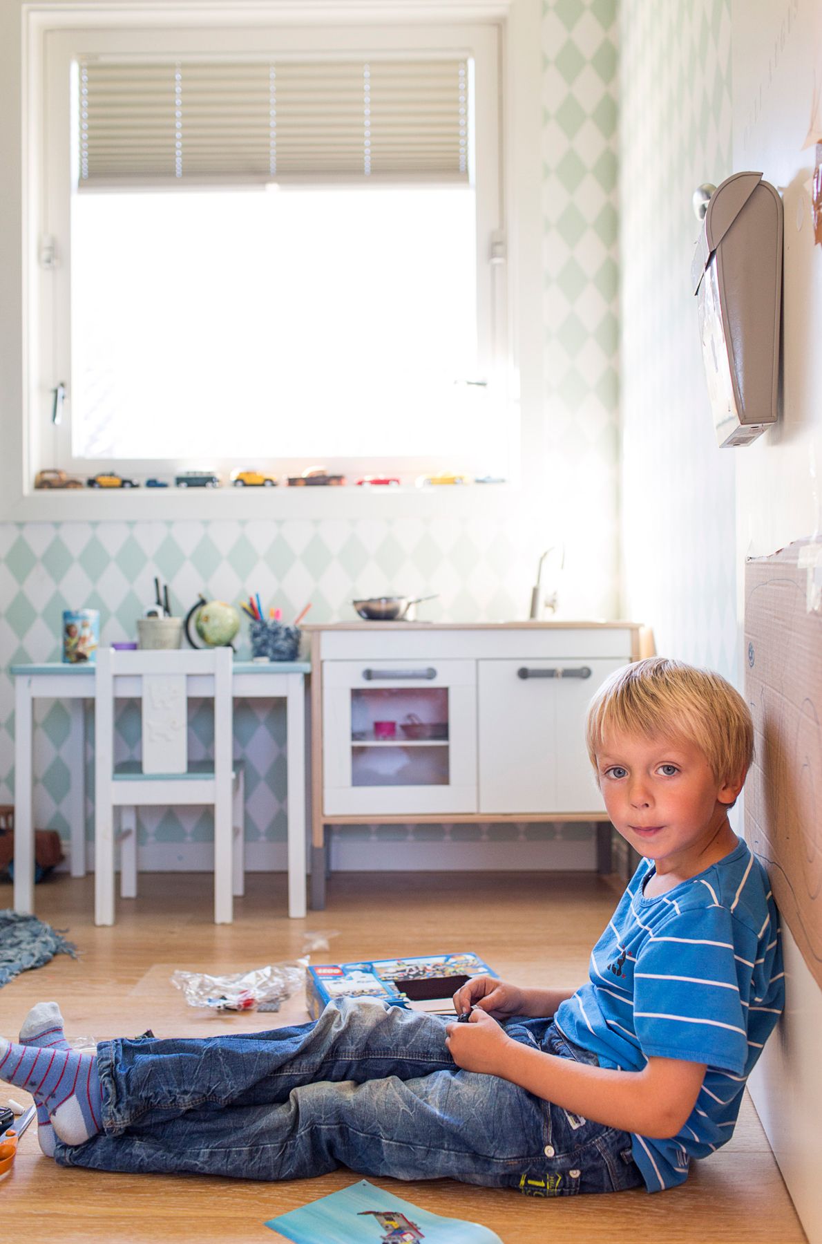 Ollin huoneen keittiönurkkaus on Ainon kokkauskäytössä. Ruututapetin valmistaja on Ferm Living.