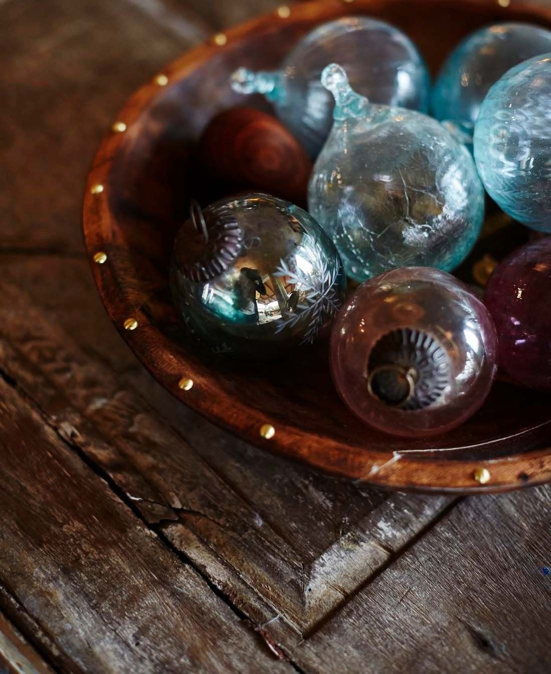 Kulttuurit kohtaavat sisustuksessa. Kenialaiset kierrätyslasikoristeet ovat esillä intialaisessa antiikkikulhossa