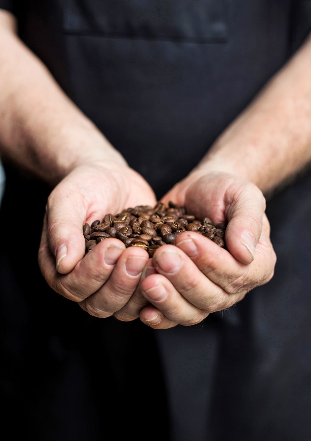 Wuori pitelee käsissään Keniasta, ystäväperheen sukutilalta lähtöisin olevia kahvipapuja.