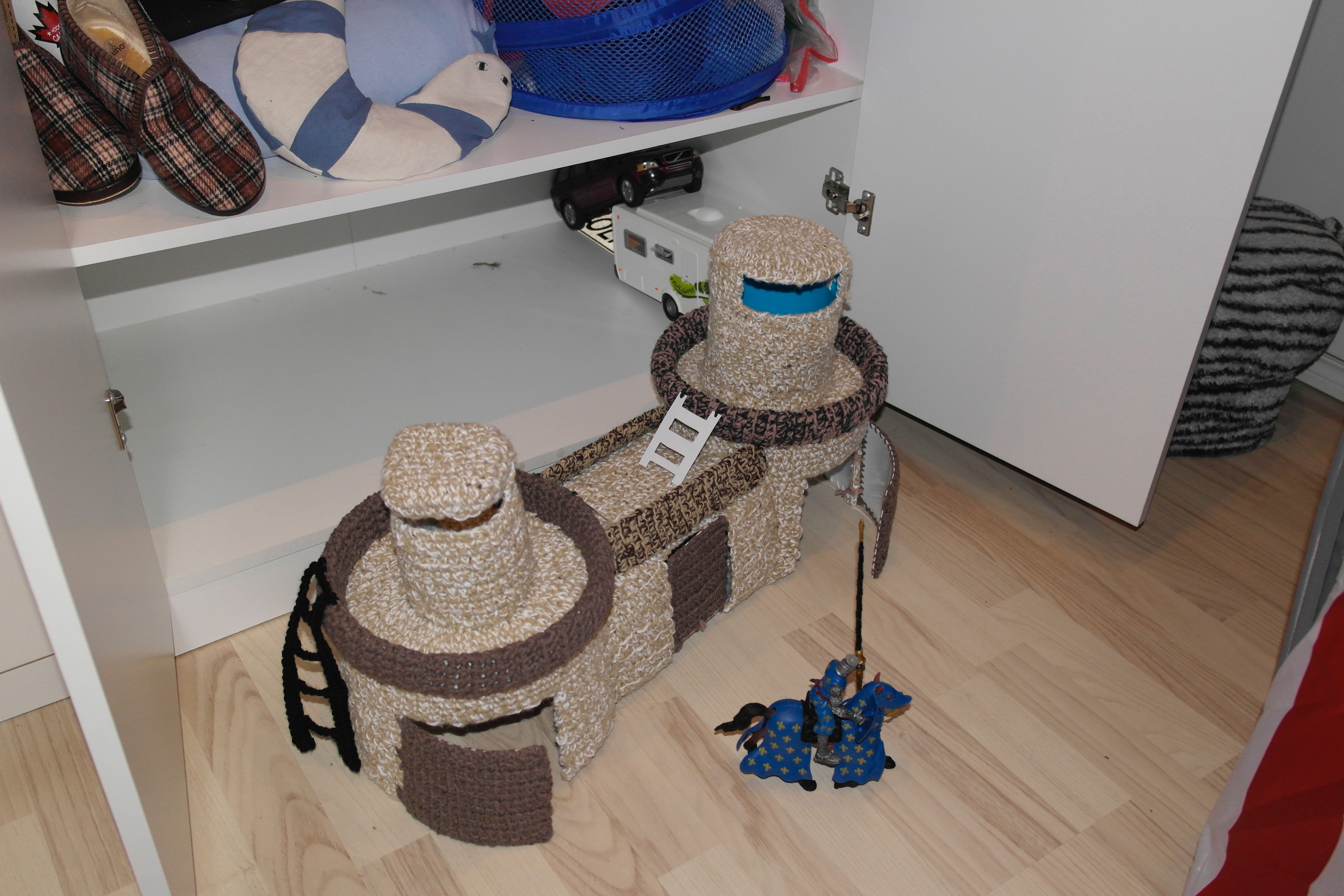 Johanna on tehnyt pojalleen myös ritarilinnan ja paloaseman virkkaamalla ne muovikanistereiden ja ämpäreiden päälle. 