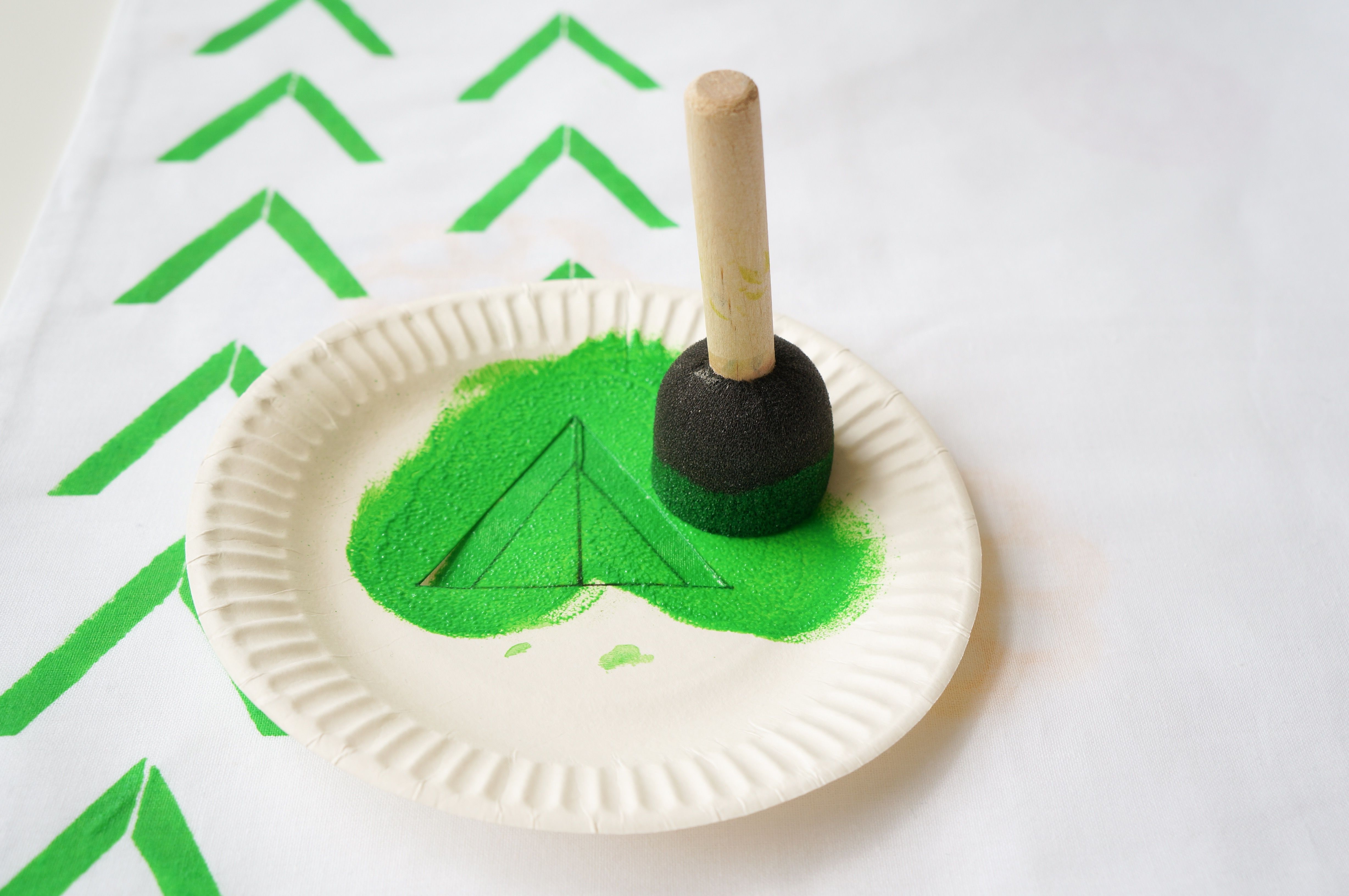 Vihreäkuvioisen tyynyn kuvio piirtyi kankaalle kirurginveitsellä viillettyjen kuvioiden läpi. 