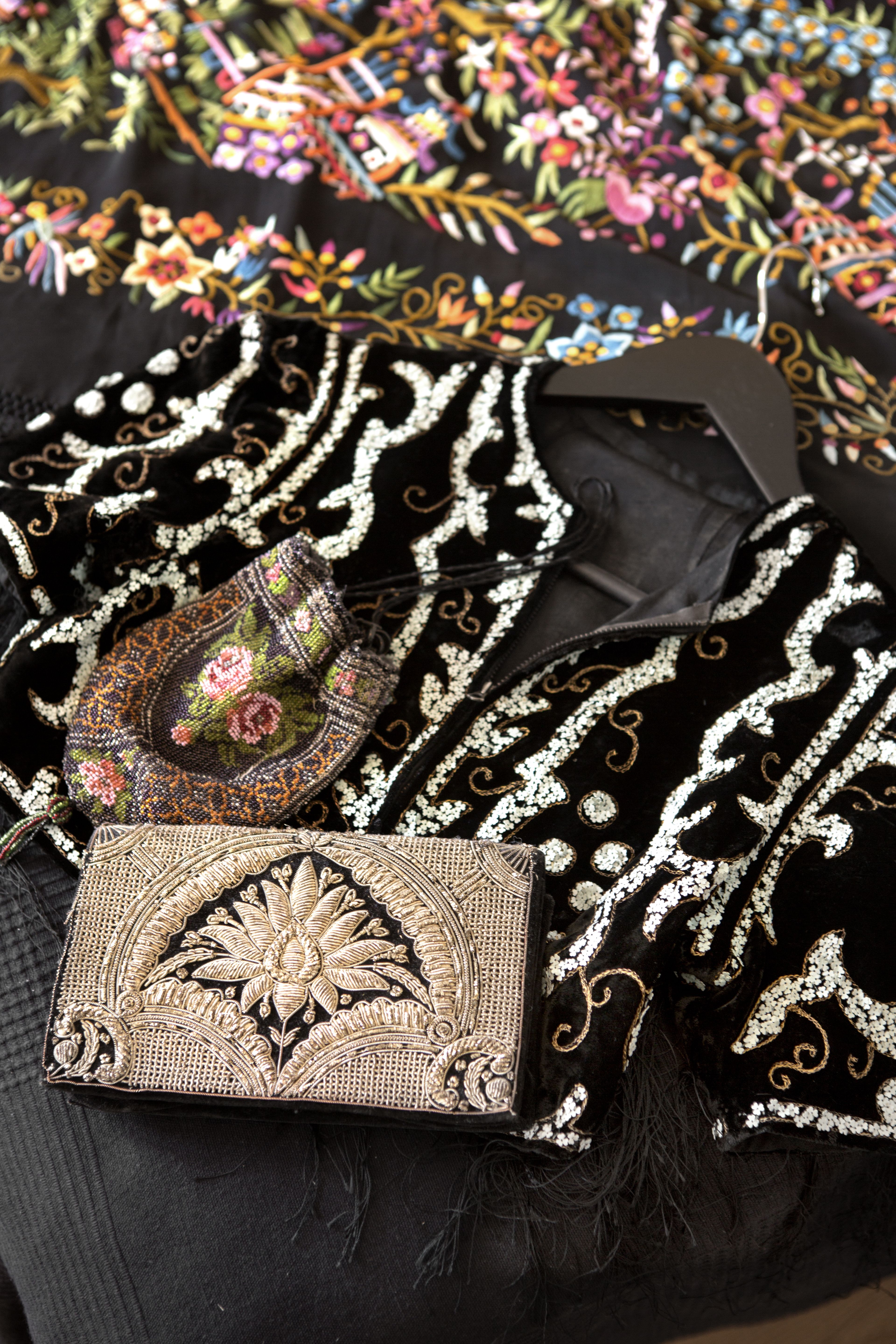 Vintagelaukkujen kokoelma on kaunis. Sängyn päällä on kirjailtu pianoshaali 1900-luvun alusta.